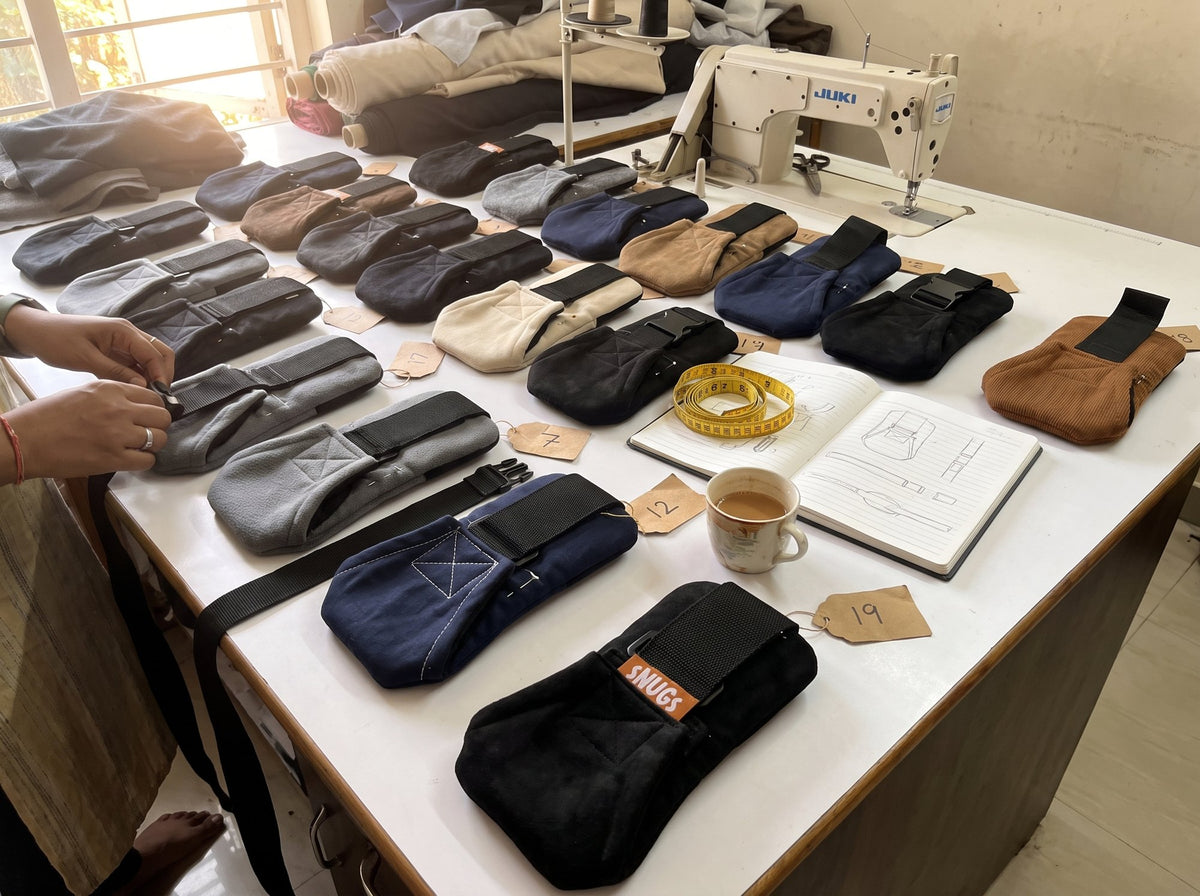Prototypes of the Snugs Sideways Carrier on the workshop table